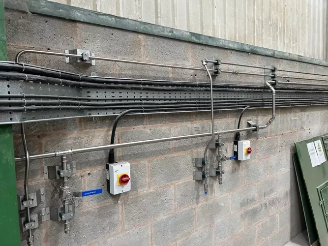Completed wash bay installation showing the feeds and outlet points supplied by the new low and high-pressure pipework system. Designed to provide convenient access for operators while keeping the wash area organised and efficient for daily use.